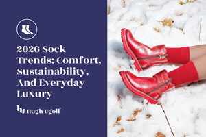 Red Hugh Ugoli socks styled with matching red boots in the snow, representing 2026 sock trends focused on comfort, sustainability, and everyday luxury.