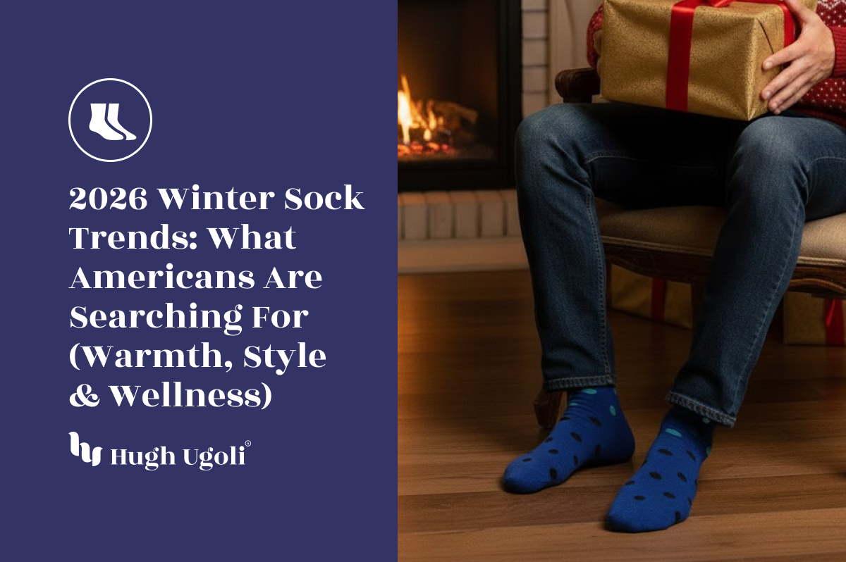 Man sitting by a fireplace holding a gift, wearing blue Hugh Ugoli socks, illustrating 2026 winter sock trends focused on warmth, style, and wellness in American households.