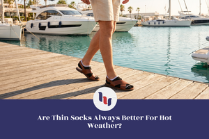 Person walking on a dock with boats in the background, wearing sandals.
