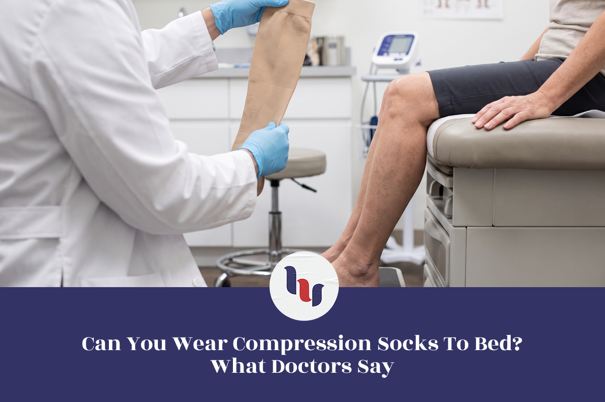 Doctor holding a beige compression sock while a patient sits on an examination table.