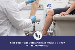 Doctor holding a beige compression sock while a patient sits on an examination table.