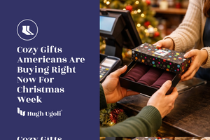 Person opening a Christmas gift box with festive decorations in the background