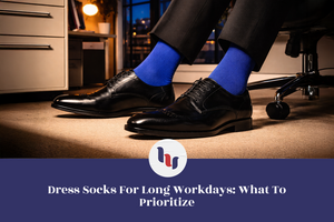 Person wearing black dress shoes and blue dress socks in an office setting.