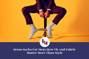 Man sitting on a stool wearing dress socks against an orange background with a logo and text overlay.