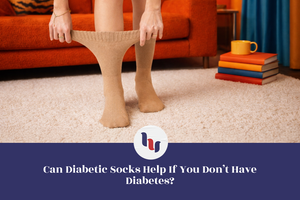 Person wearing beige diabetic socks in a living room setting with books and a cup.