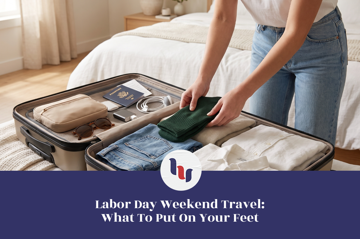 Woman packing green socks and travel essentials into an open suitcase for Labor Day weekend.