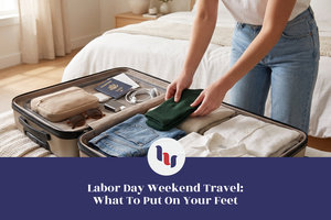 Woman packing green socks and travel essentials into an open suitcase for Labor Day weekend.
