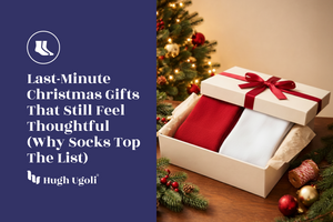 Gift box with red socks and white underwear, Christmas tree in the background with Hugh Ugoli logo
