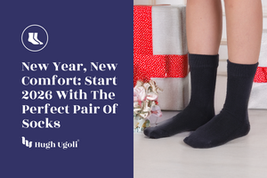 Black Hugh Ugoli socks worn near wrapped New Year gifts, symbolizing fresh beginnings, comfort, and cozy winter essentials for 2026.