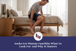 Man holding his heel after getting out of bed.