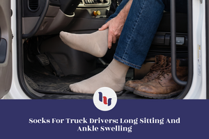 Truck driver seated in a vehicle wearing beige crew socks and holding his ankle beside work boots.