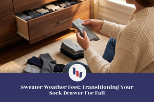 Woman organizing gray socks beside an open sock drawer for the fall season.