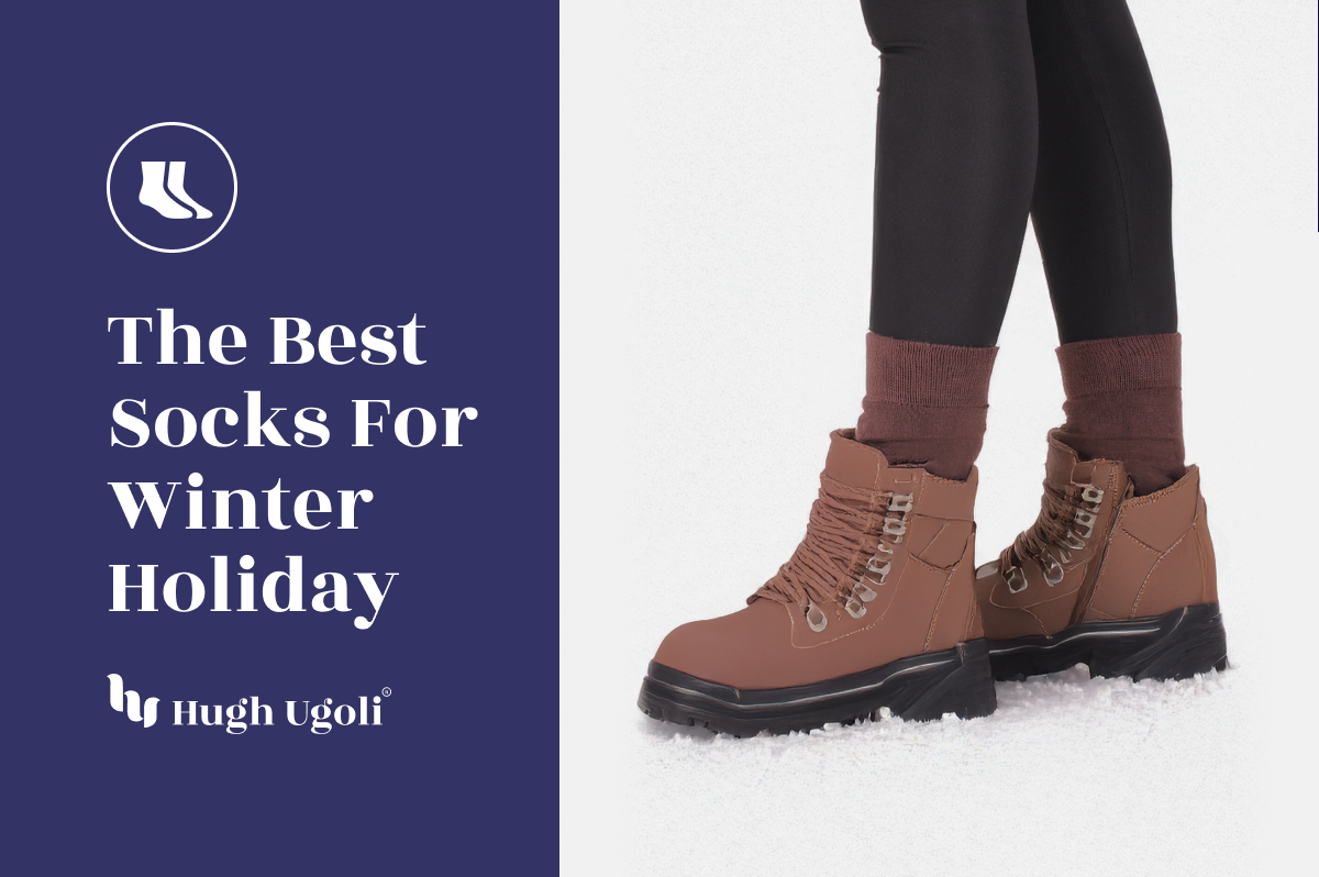 Brown winter boots with socks on a snowy ground, featuring Hugh & Goliath branding.