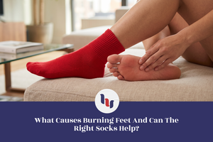Person wearing red crew socks touching the sole of their foot, illustrating burning feet discomfort and the role of supportive socks