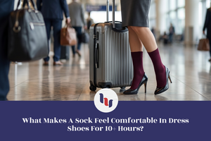 Person with suitcase in a busy airport terminal, wearing dark dress shoes and maroon socks.