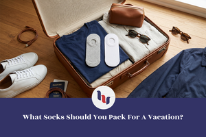 Packed suitcase with no-show socks and travel essentials ready for vacation.