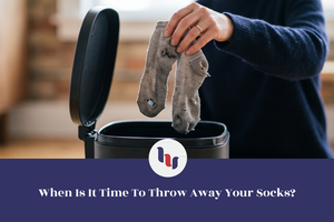 Worn-out socks being thrown into a trash bin.