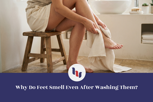 Person sitting on a stool with a towel around their legs in a bathroom setting.