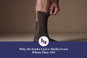 Person gently pulling down a crew sock to show sock marks on the lower leg.