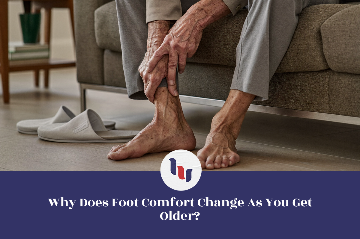 Older adult holding an aching foot at home, illustrating how foot comfort changes with age.