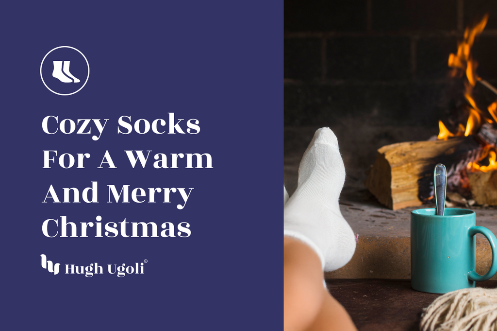Feet in cozy white socks resting by a fireplace, with a warm drink in a teal mug, evoking a merry Christmas atmosphere.