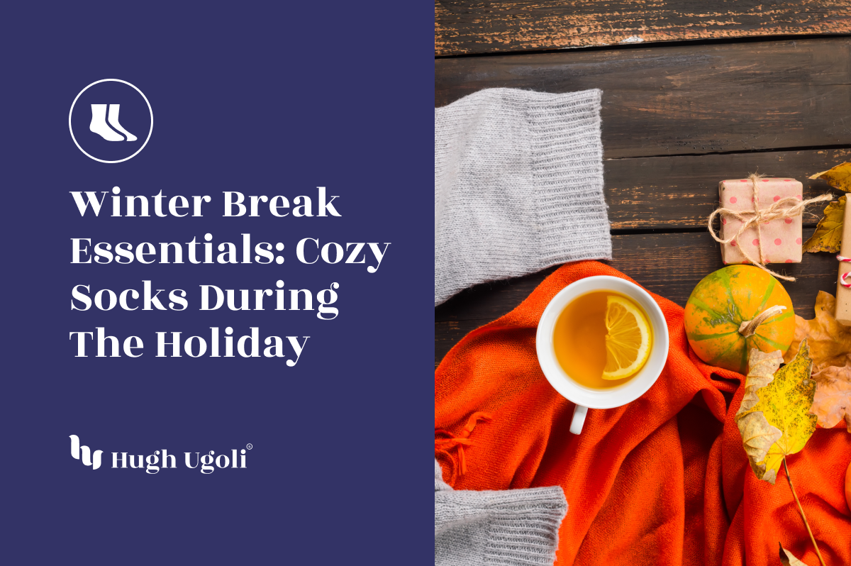 Flat lay of cozy winter essentials featuring a cup of tea with lemon, an orange blanket, grey socks, a small pumpkin, and wrapped holiday gifts on a wooden surface with autumn leaves.