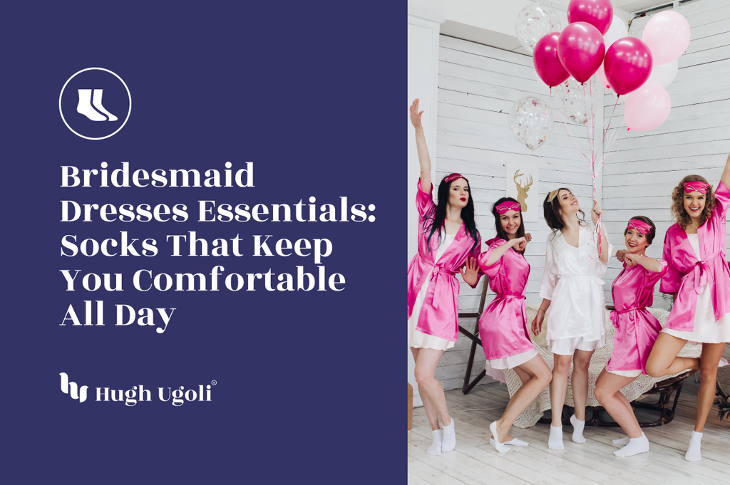Group of bridesmaids and bride in pink and white satin robes, holding pink balloons, wearing white socks, celebrating indoors with joyful poses.