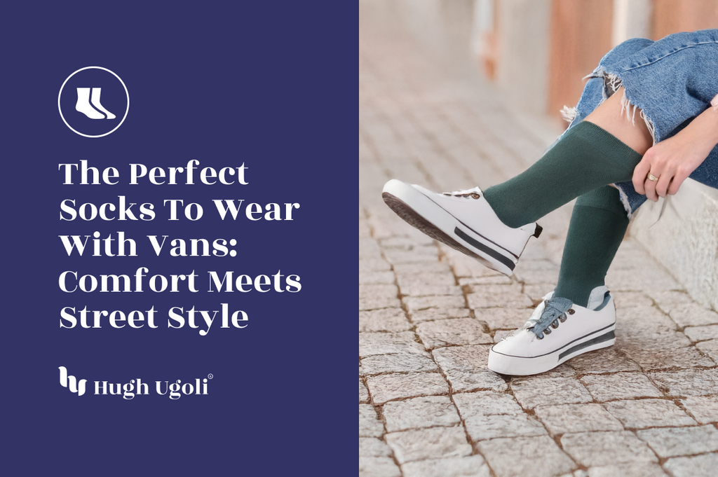 Person wearing green knee-high socks with white Vans sneakers, sitting on cobblestone pavement in a casual street-style outfit.