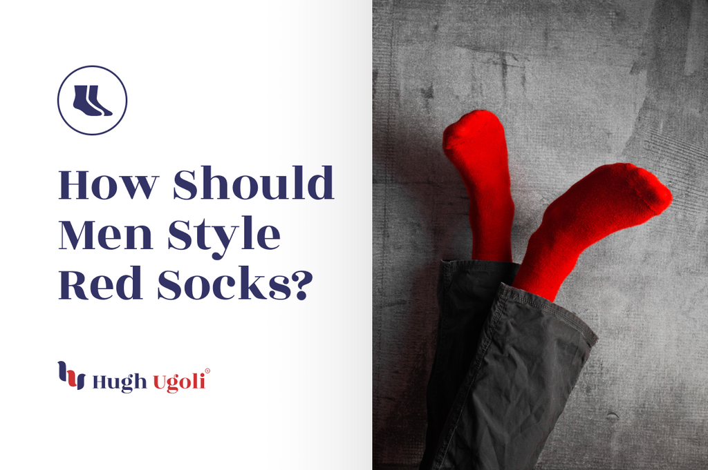 Man styling bold red socks, paired with dark gray pants, offering a vibrant pop of color and personality in fashion.
