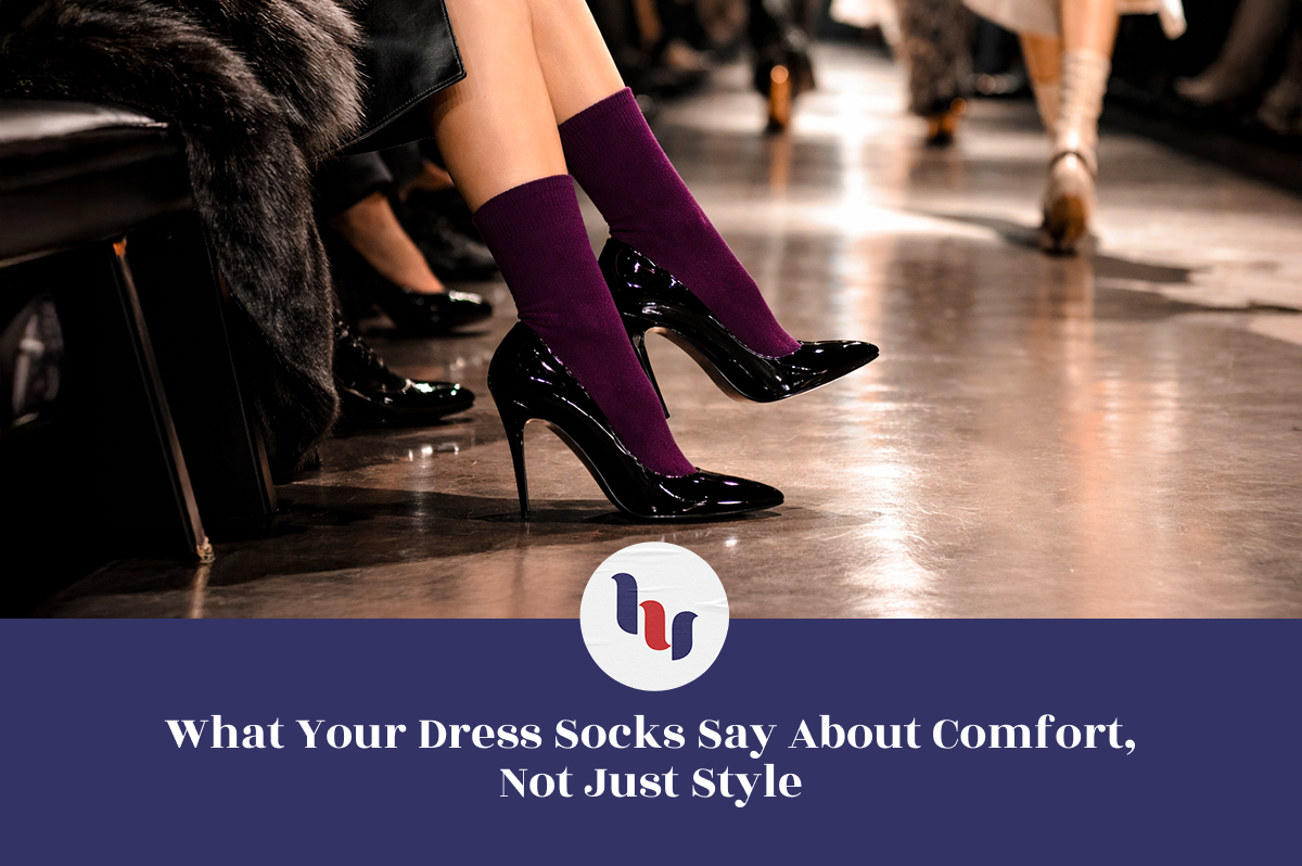 Person wearing high-heeled shoes and purple dress socks on a runway.