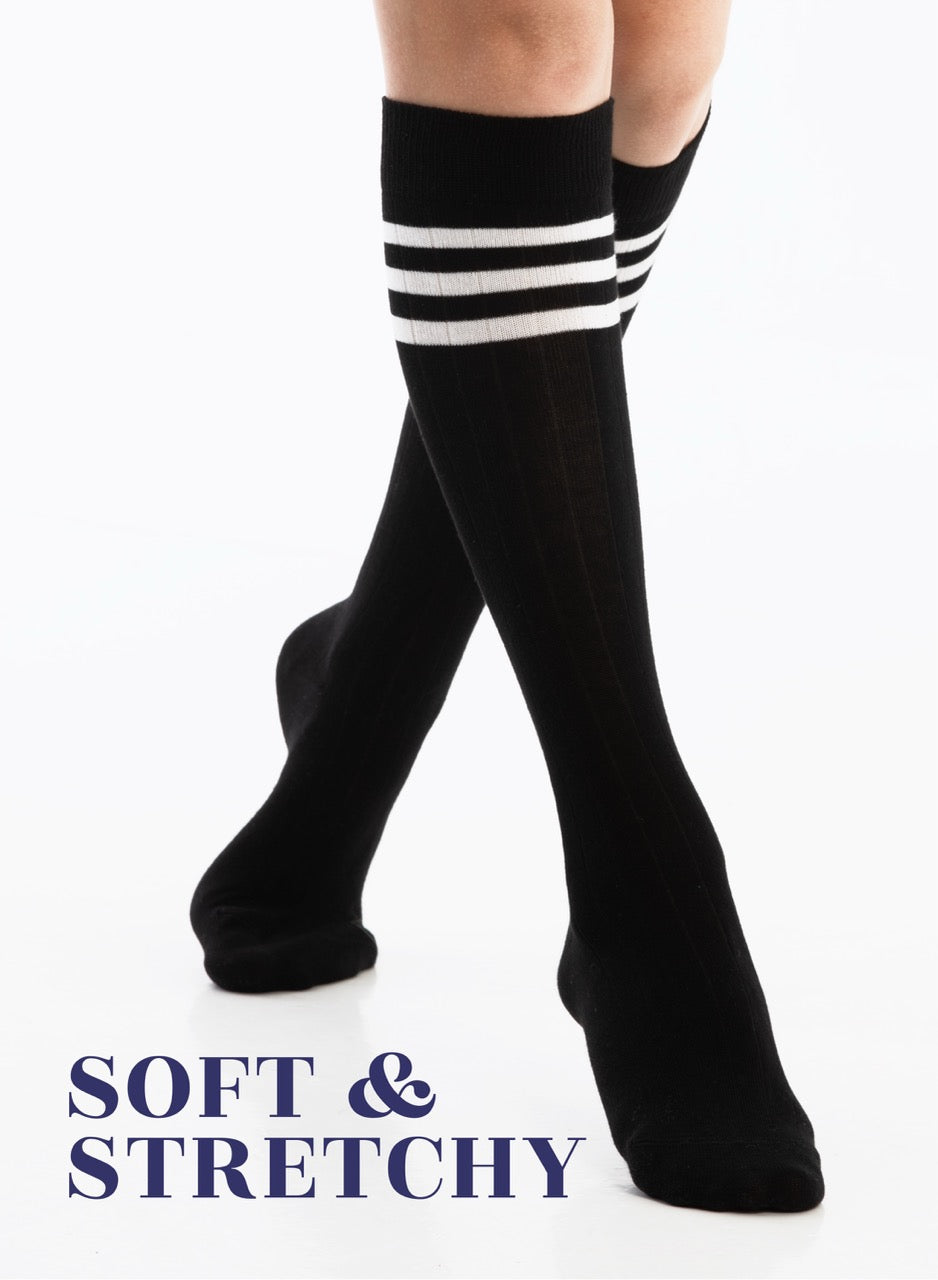 Black knee-high socks with white stripes on a white background
