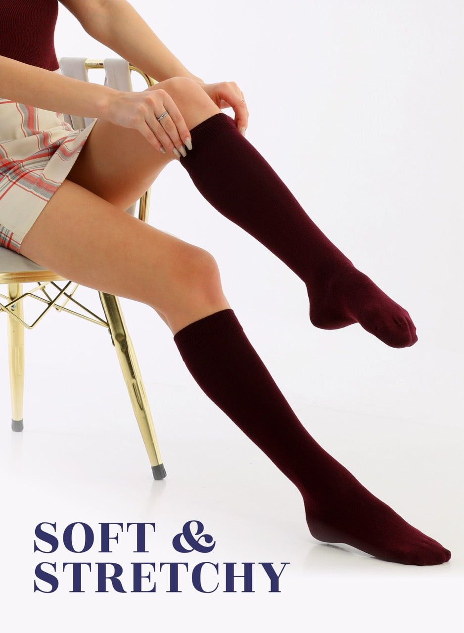 Person wearing maroon knee-high socks with text 'Soft & Stretchy' on a white background
