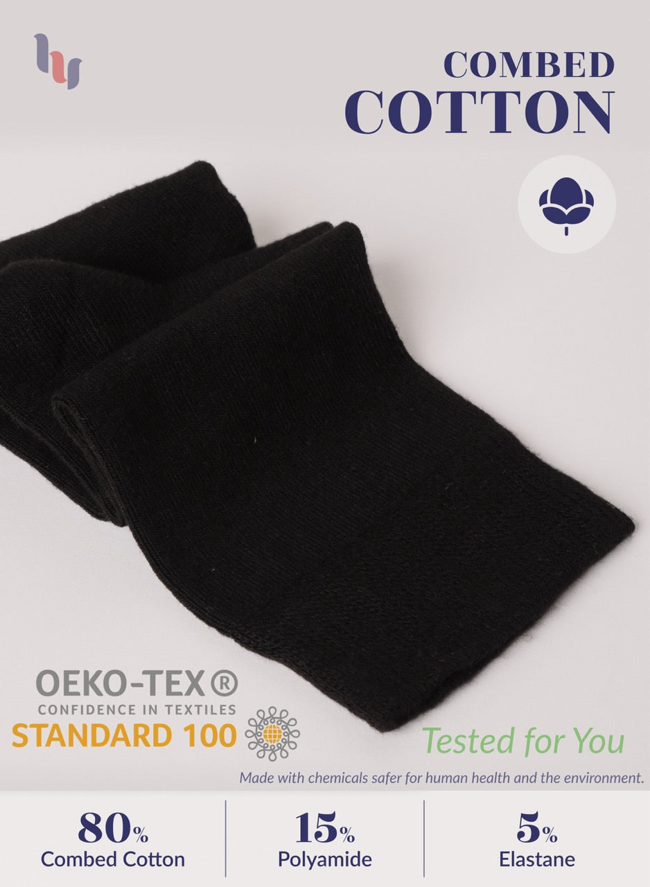 Black fabric with OEKO-TEX and Combed Cotton labels on a light gray background