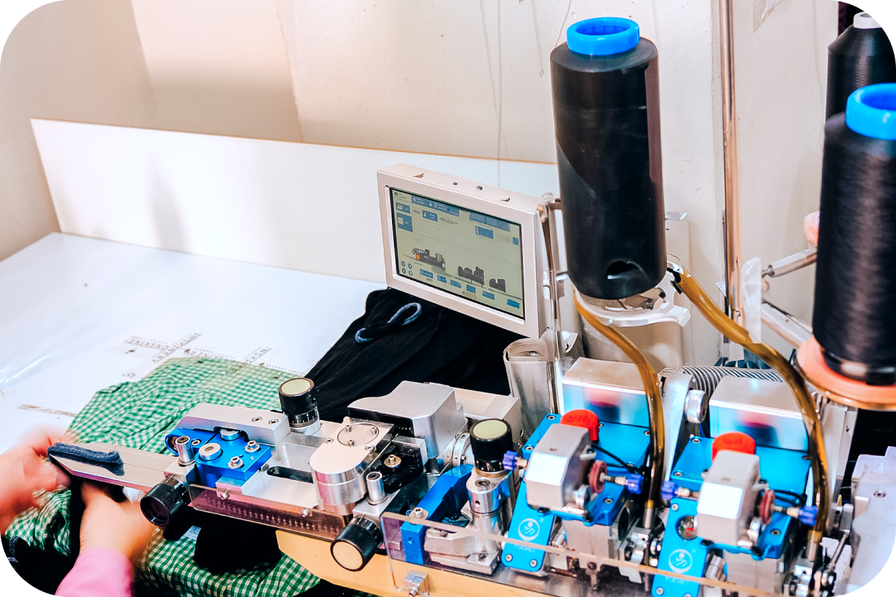 A person operating a shirt-making machine, diligently crafting a shirt with precision and expertise.
