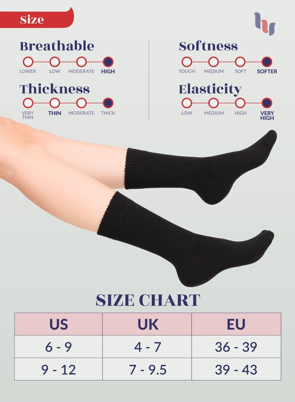 Black socks being worn with size chart and feature indicators on a light gray background