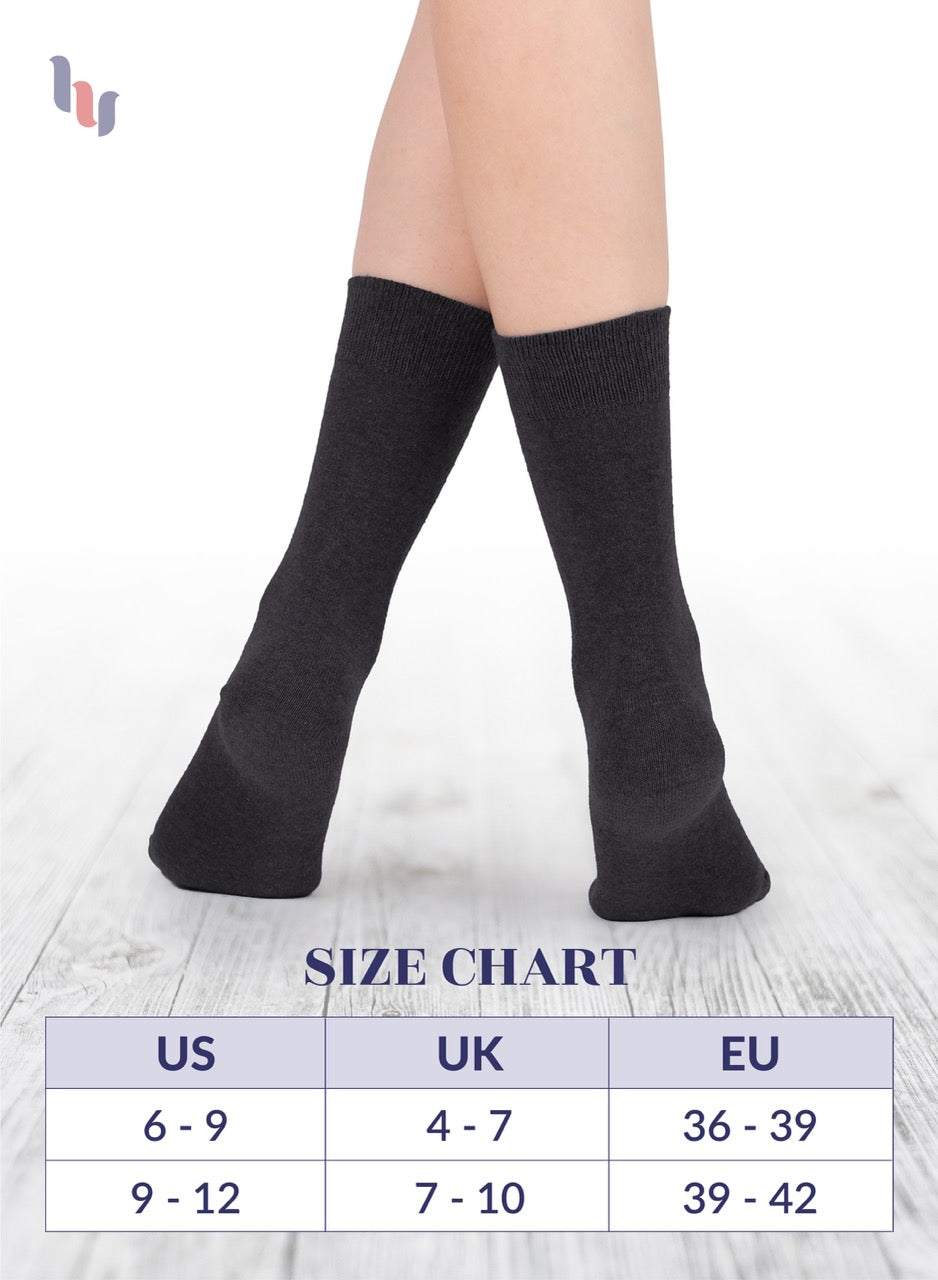 Dark gray knee-high socks on a person's legs with a size chart below.