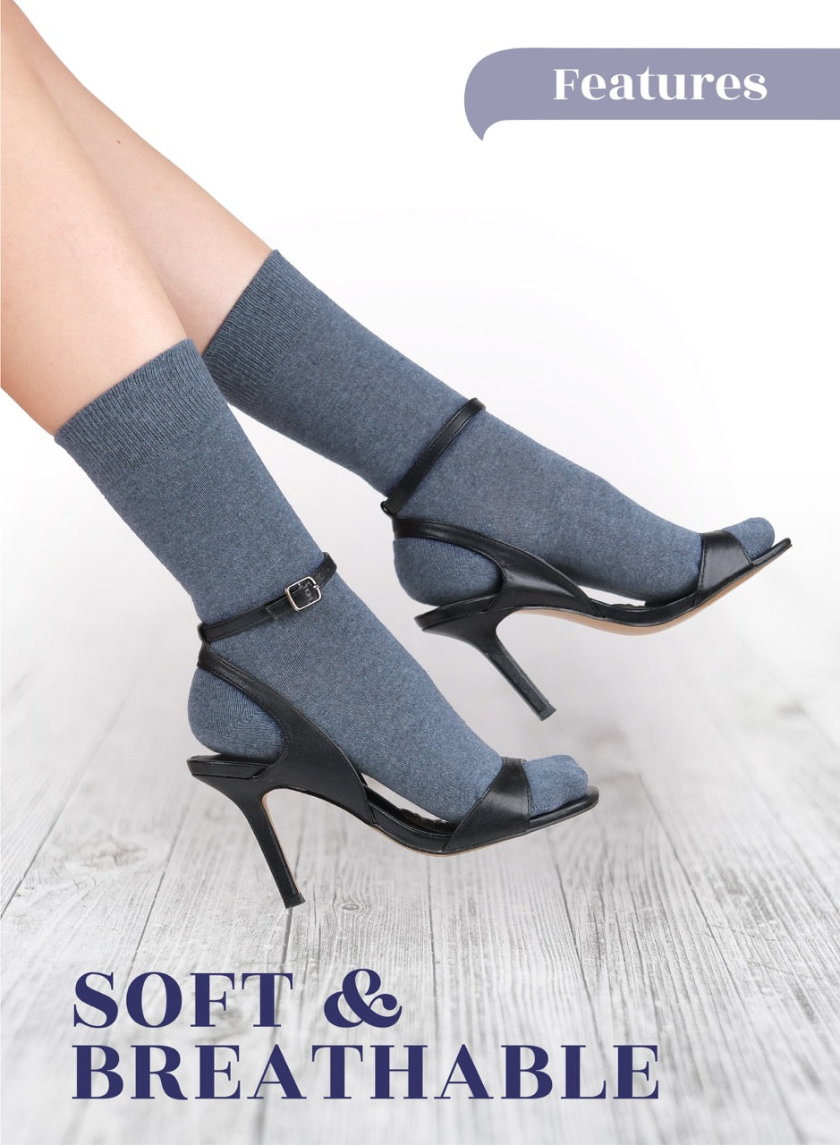 Indigo socks with black high-heeled shoes on a light wooden floor, with 'Soft & Breathable' text.