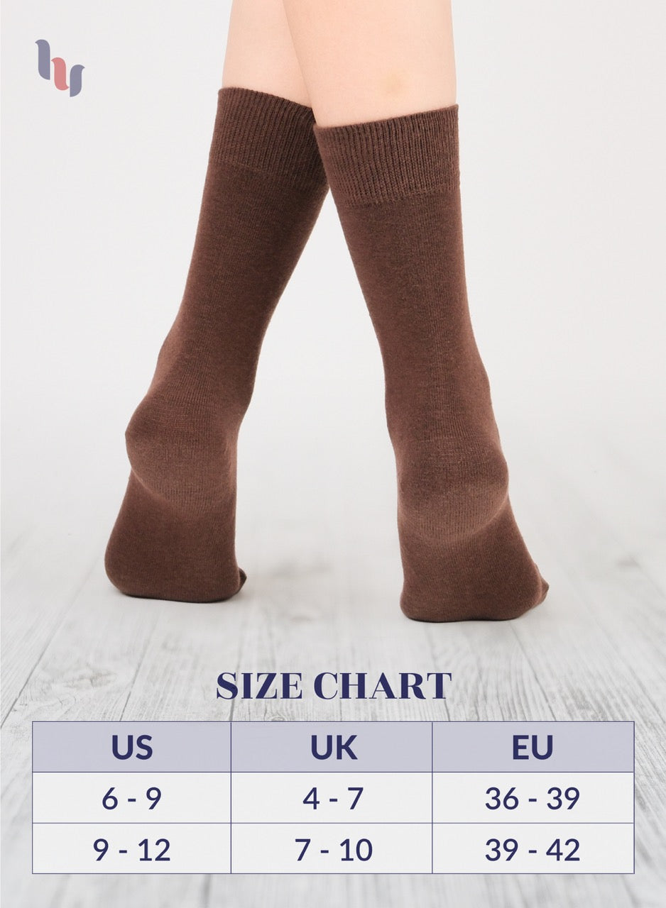 Light brown knee-high socks on a person with a size chart below on a light gray background
