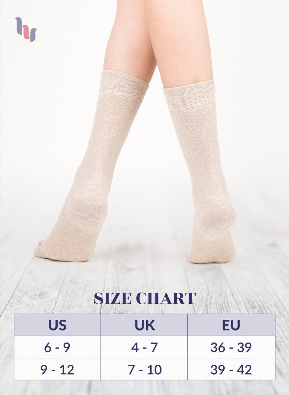 Light beige knee-high socks on a person's legs with a size chart below.