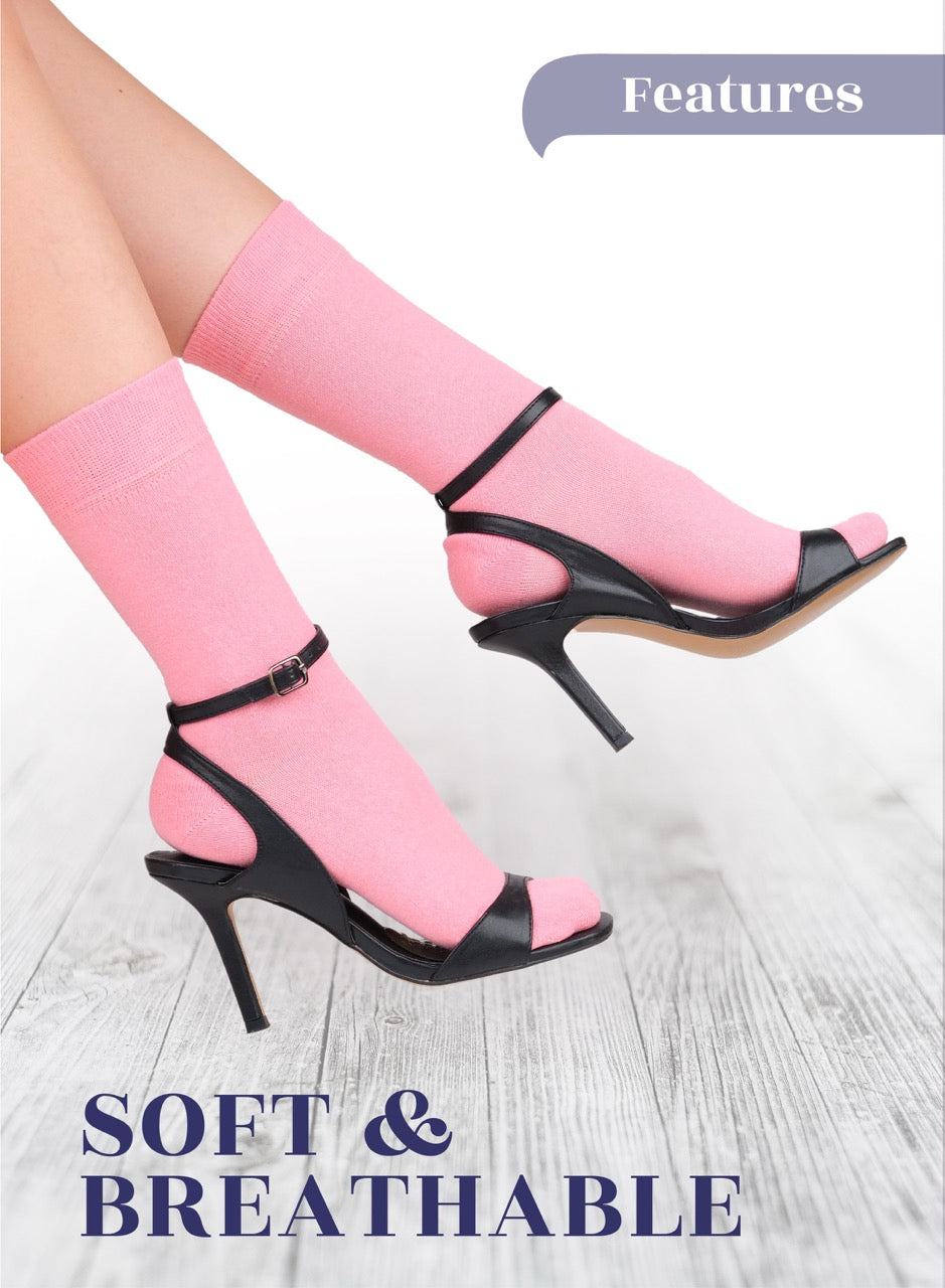 Black high-heeled shoes with pink socks on a light wooden floor, featuring text 'Soft & Breathable'.