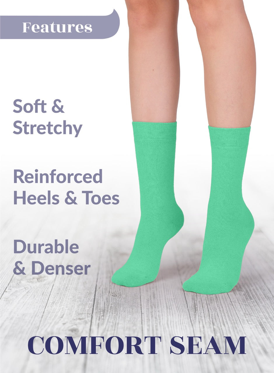 Green socks with text highlighting features on a light wooden floor background
