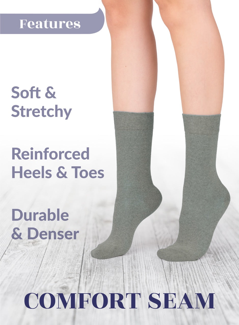 Gray socks with text highlighting features on a light wooden floor background