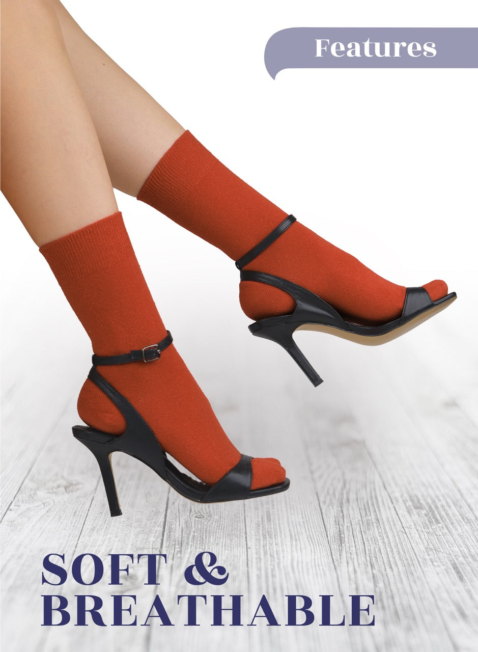 Orange socks with black high-heeled shoes on a light wooden floor, with 'Features' and 'Soft & Breathable' text.