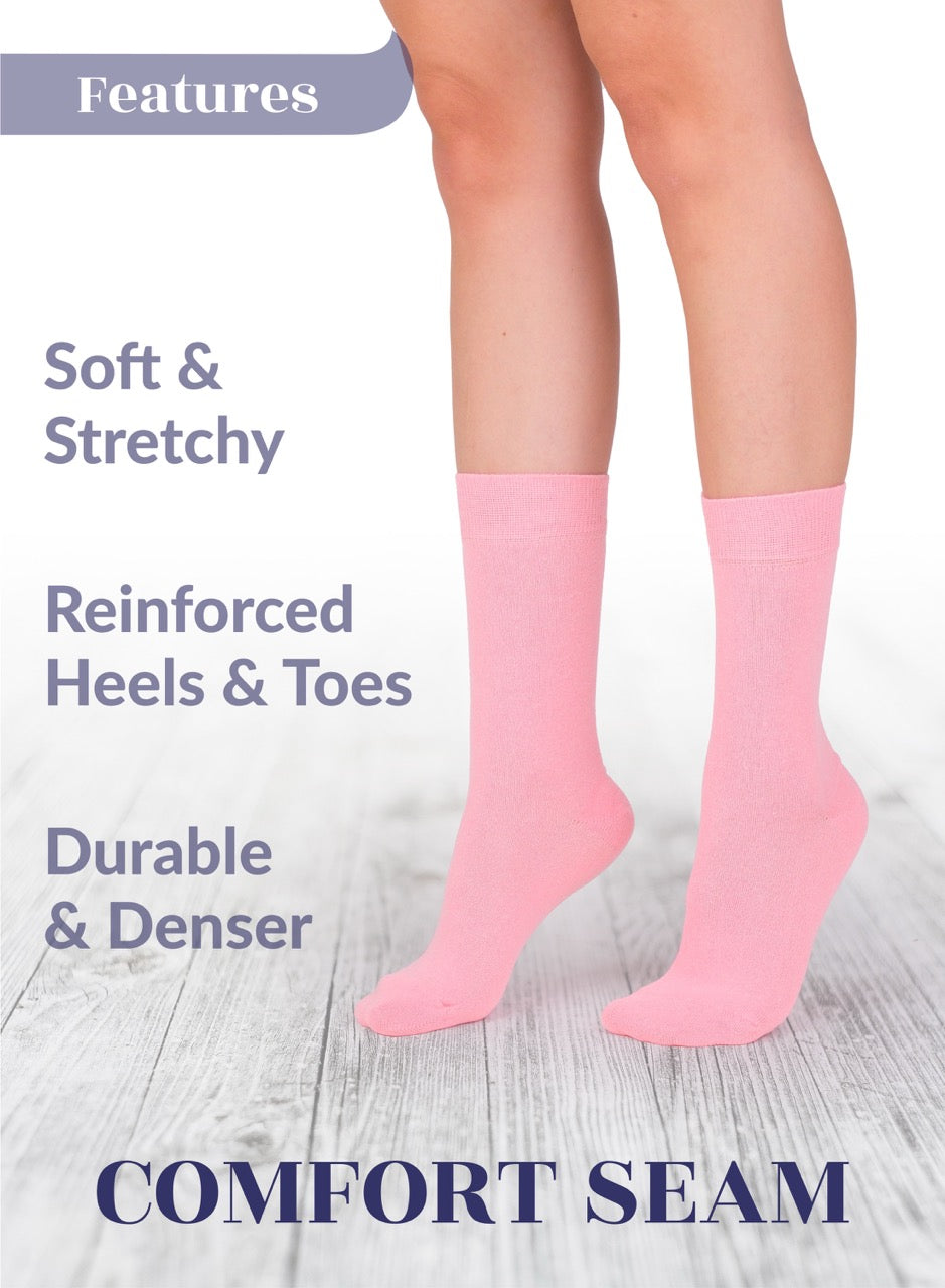 Pink socks with text highlighting features on a light wooden floor background