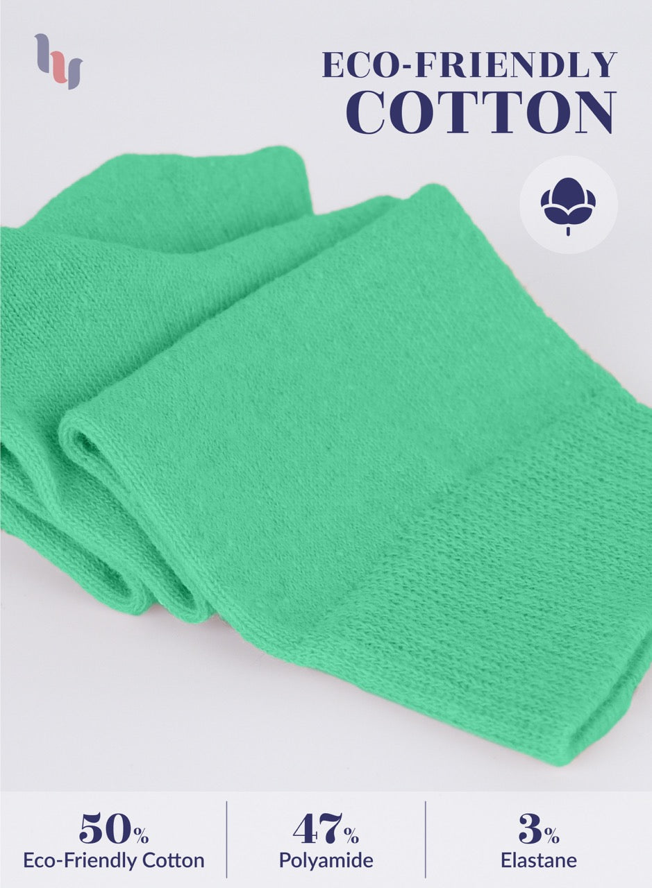 Green socks with eco-friendly cotton label on a light gray background