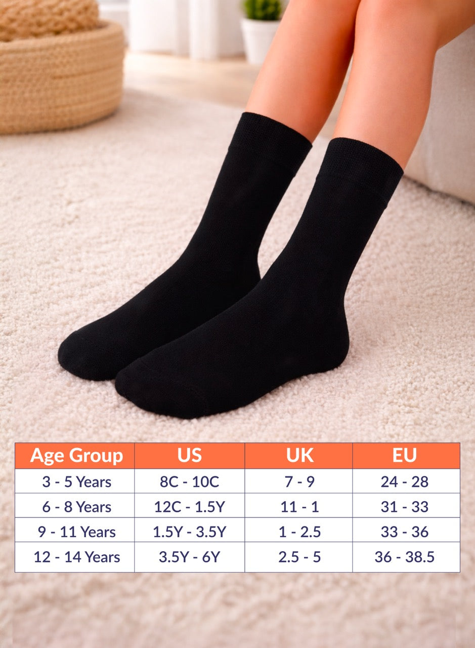 Black socks on a person's feet with a size chart below on a light background