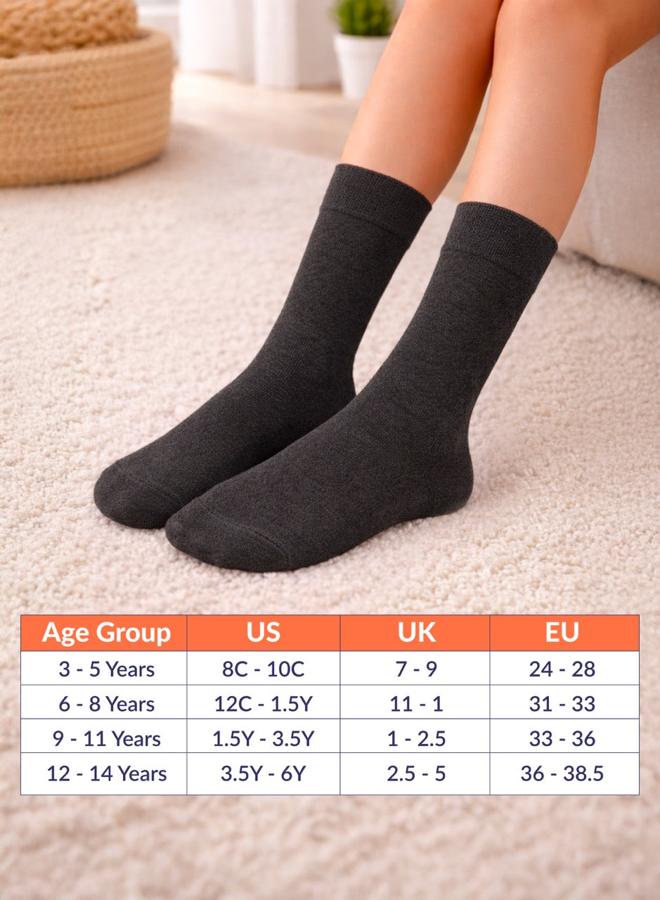 Person wearing charcoal socks with a size chart below on a light background