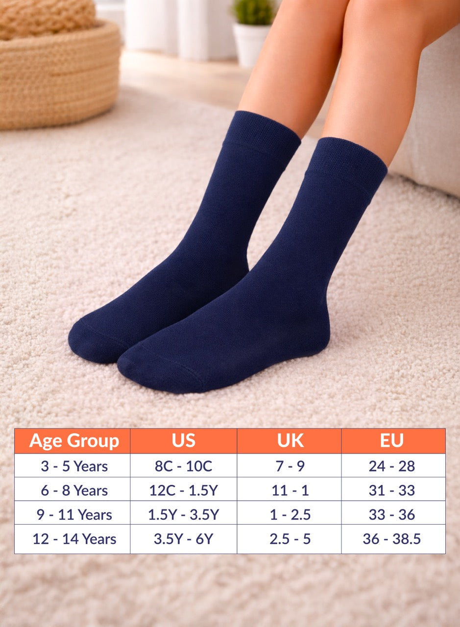 Navy blue socks on a person's feet with a size chart below on a carpeted floor.