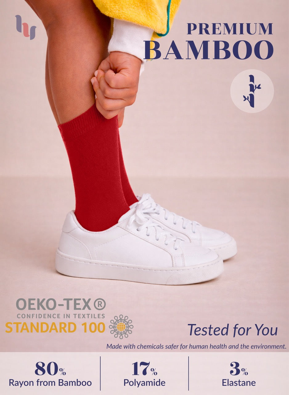 Person wearing red socks and white sneakers with text about premium bamboo and OEKO-TEX certification.