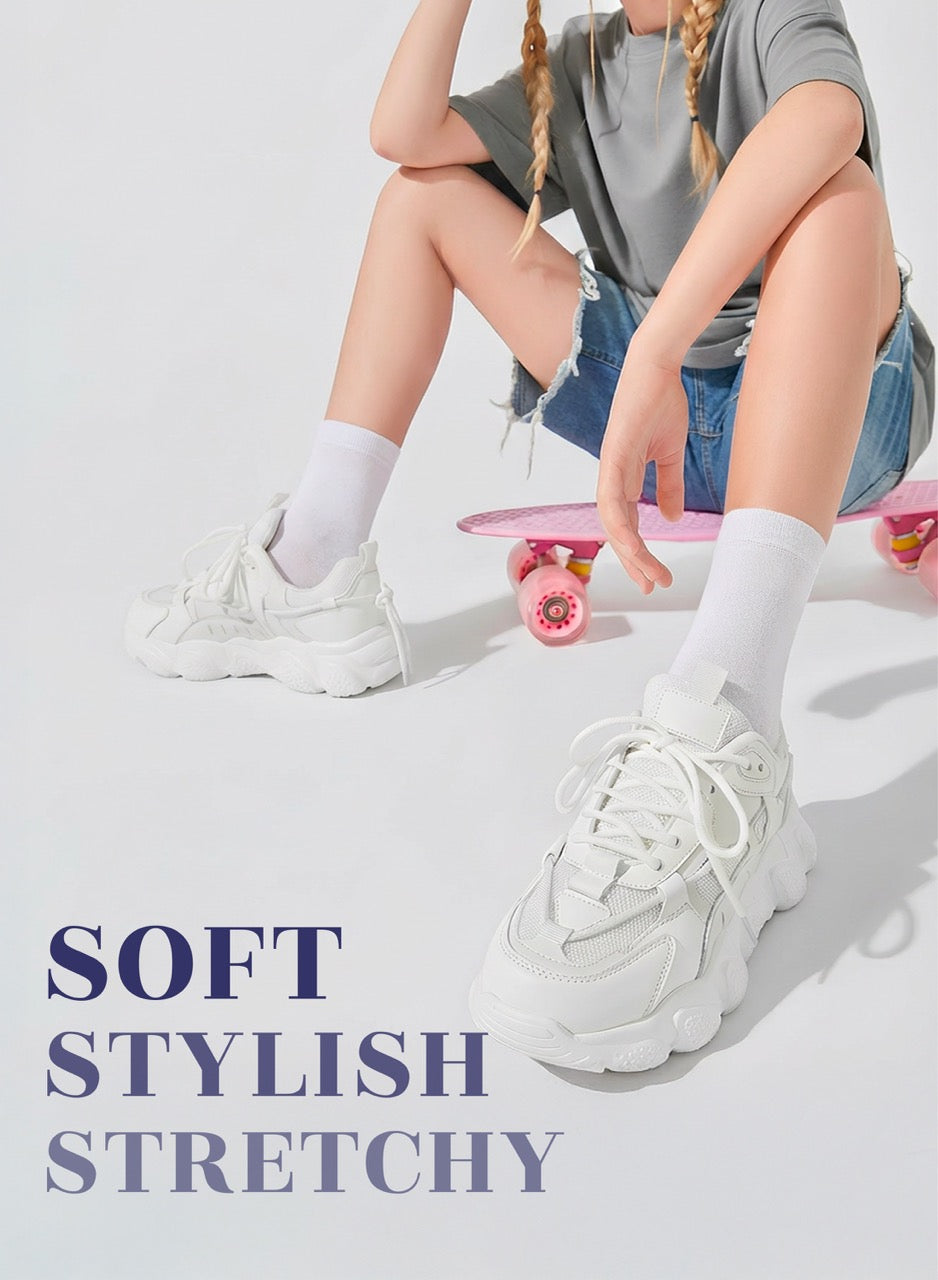 Person wearing white sneakers with text 'SOFT STYLISH STRETCHY' on a light background